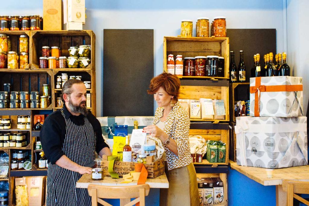 Riccardo Lunardi helping a customer to choose products
