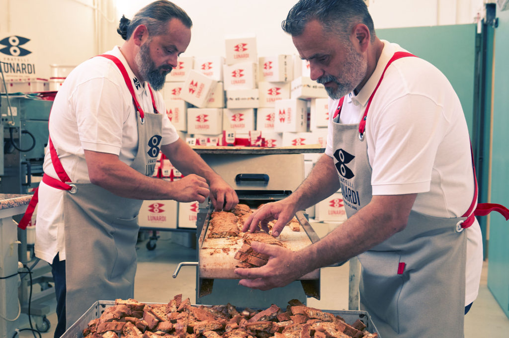 Massimiliano and Riccardo Lunardi taking almonds biscuits
