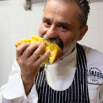 Massimiliano Lunardi eating a slice of panettone