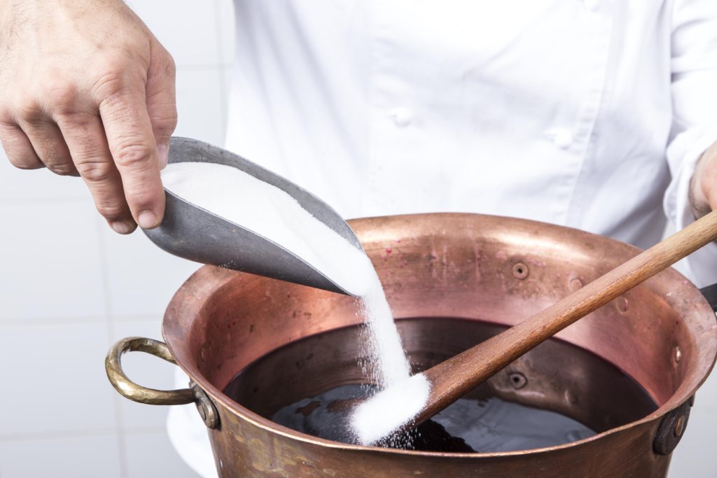Massimiliano Lunardi making caramel in a copper pot